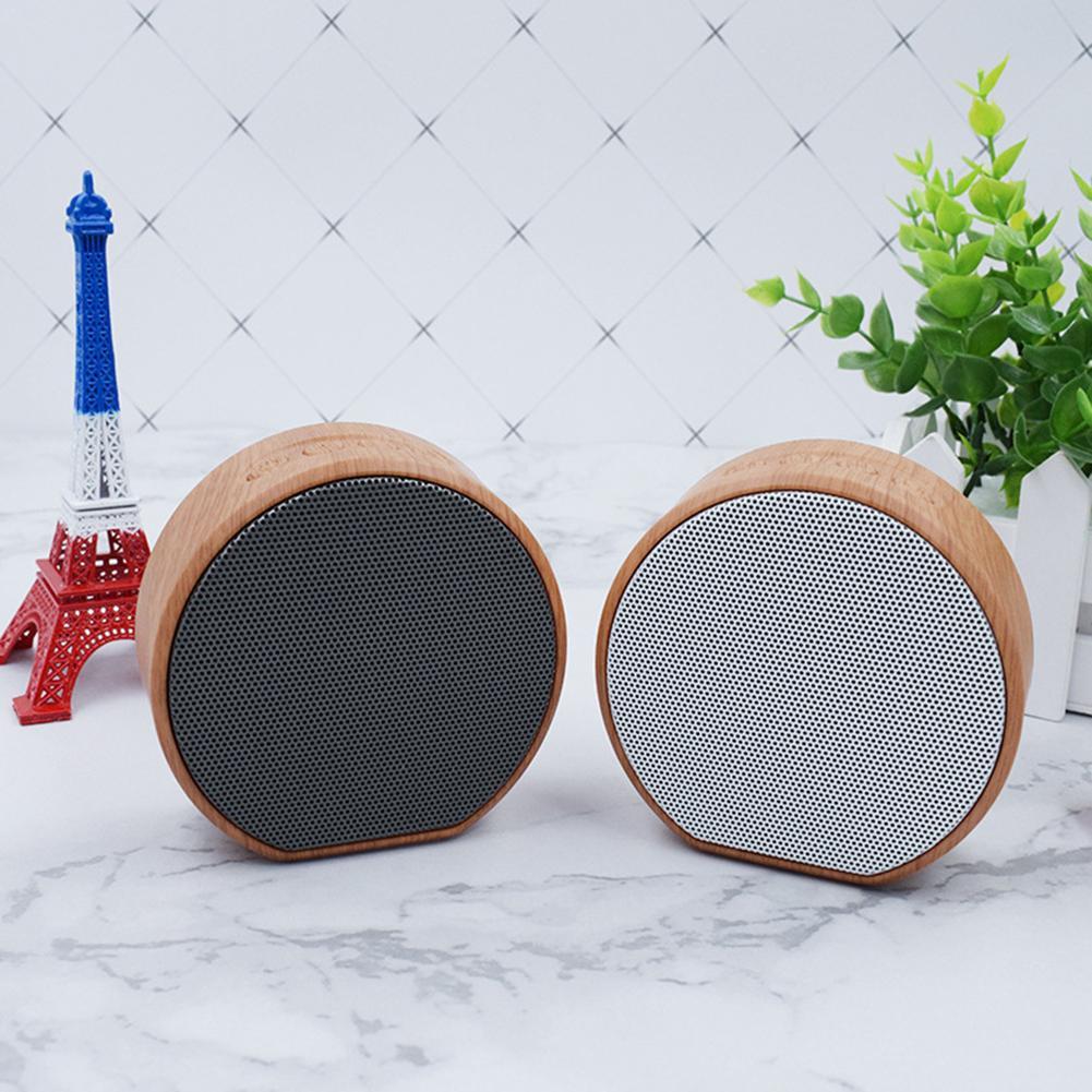 Pair of Mini Wood Bluetooth Speakers with black and white mesh grilles, perfect for wireless outdoor audio and stylish home decor.