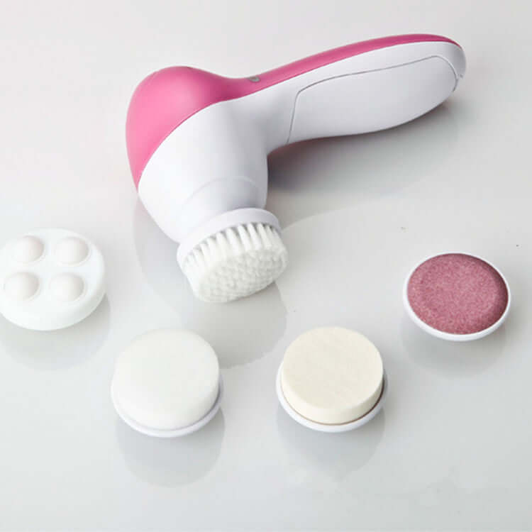 Compact electric facial cleanser with five interchangeable heads for cleansing, exfoliating, massaging, and makeup application in pink and white design