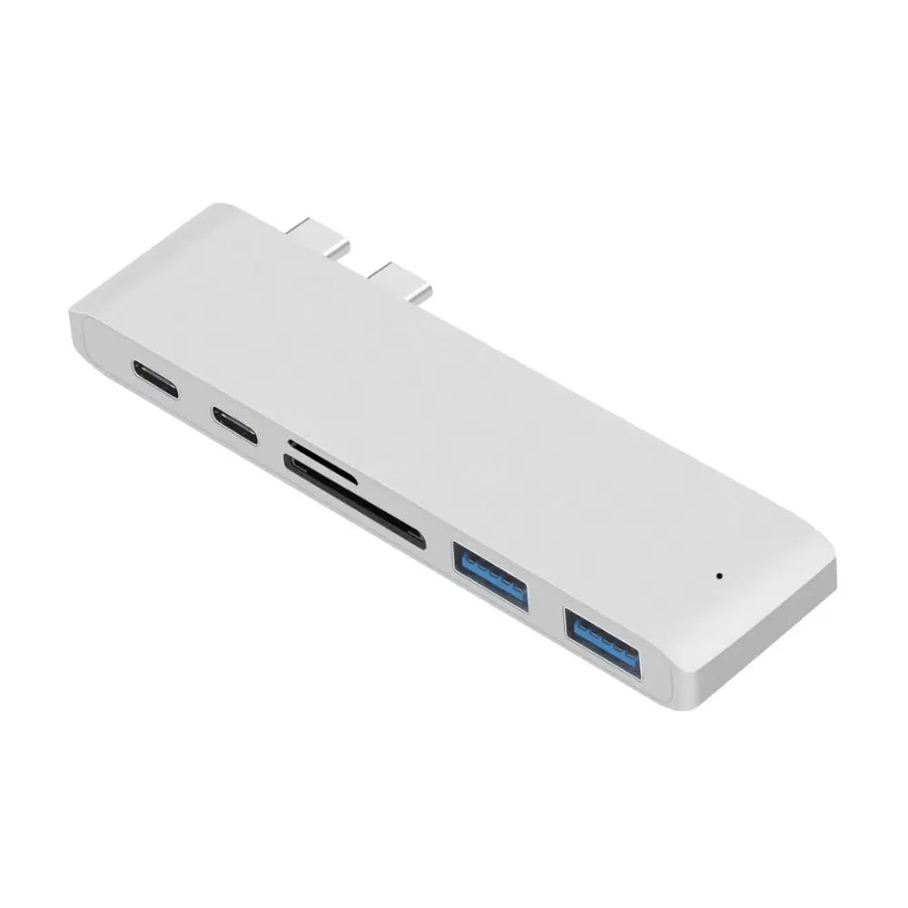 Silver USB C Hub Adapter for MacBook Pro with 6 ports including USB 3.0, SD/TF card readers, and USB-C. Sleek and minimalist design.
