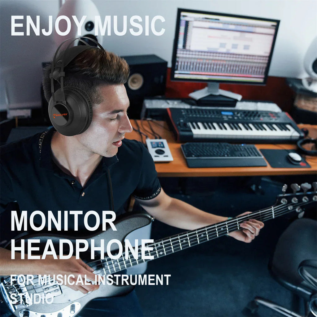 Man wearing Miwayer Studio Monitor Headphones wired over ear in music studio playing guitar with computer and keyboard in background