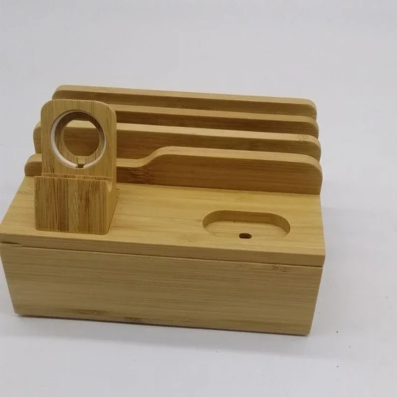 Empty bamboo charging station organizer with four device slots and smartwatch stand. Smooth finish and eco-friendly bamboo build.
