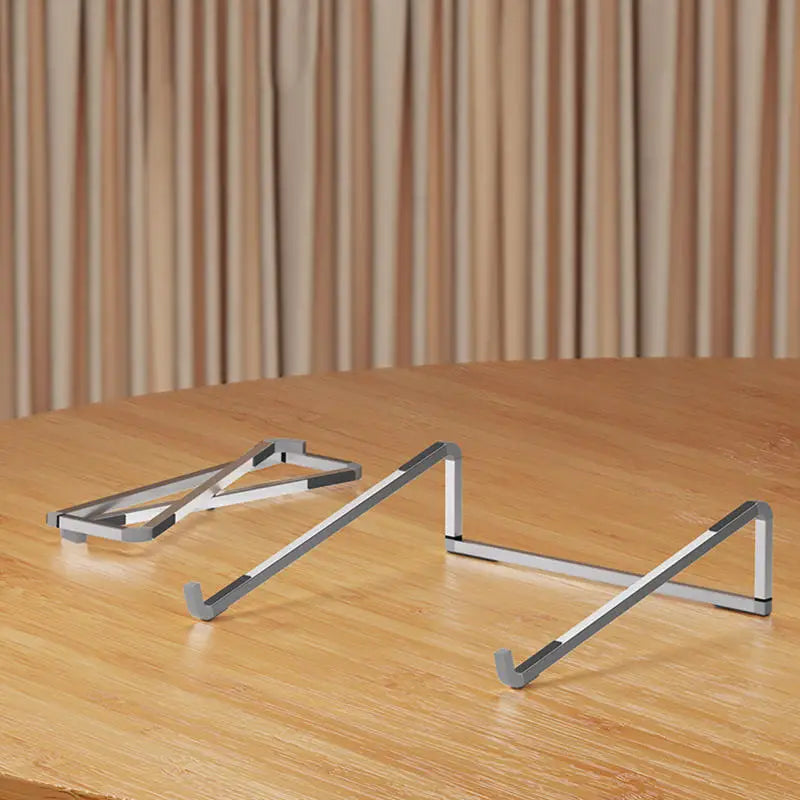 Foldable adjustable aluminum alloy laptop stand on wooden surface with triangular support design