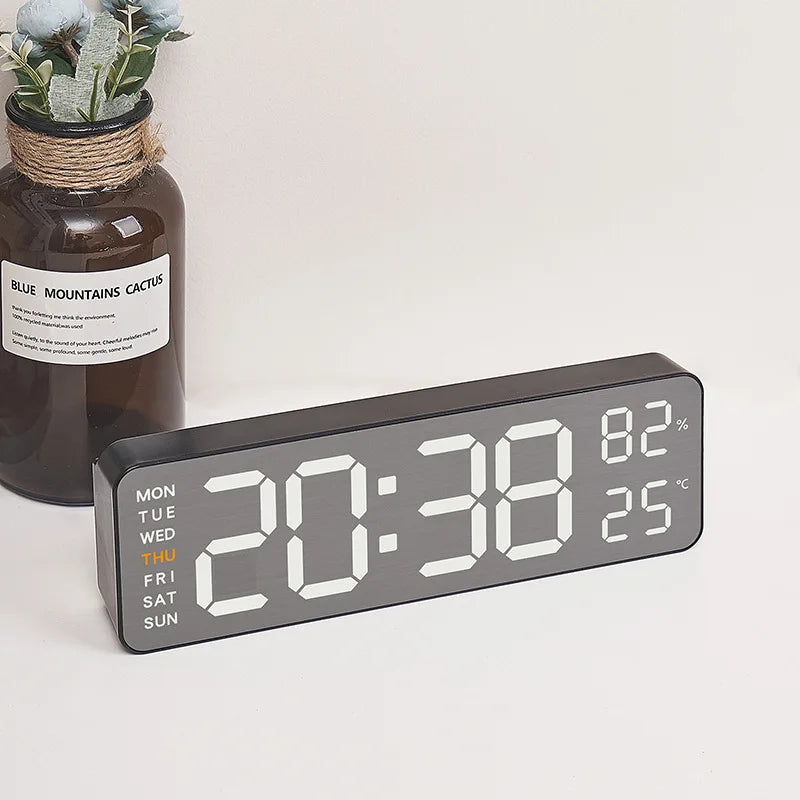Sleek digital wall clock with humidity and temperature display, perfect for contemporary office or home environments.