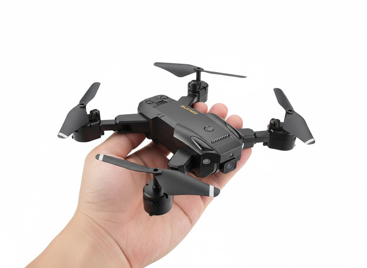Small black drone held in a hand against a white background