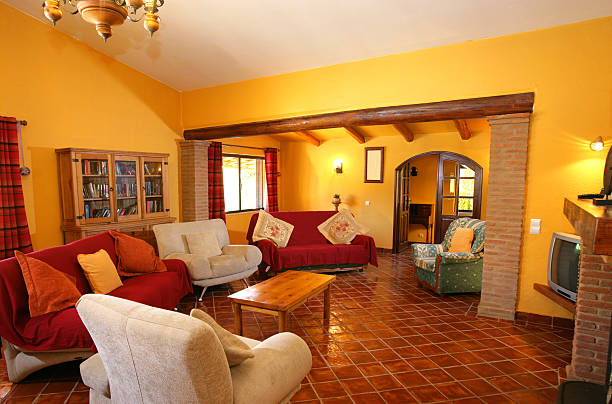 Living room with red sofa, white armchair, and wooden coffee table in a home setting.